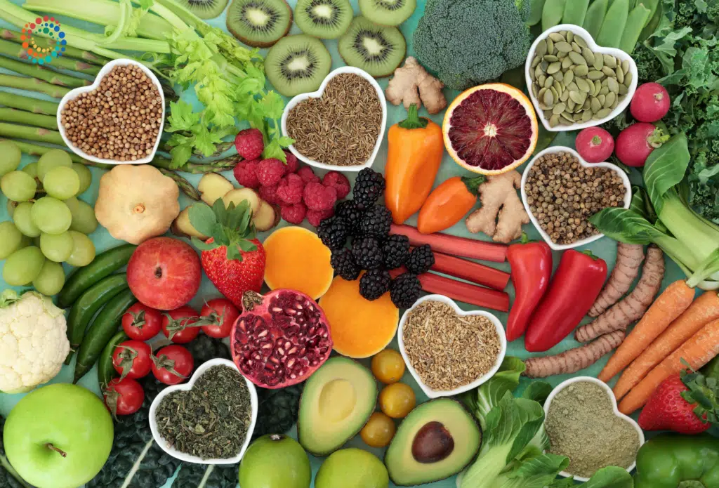 Top down view of a spread of health produce with nuts and seed in heart-shaped bowls