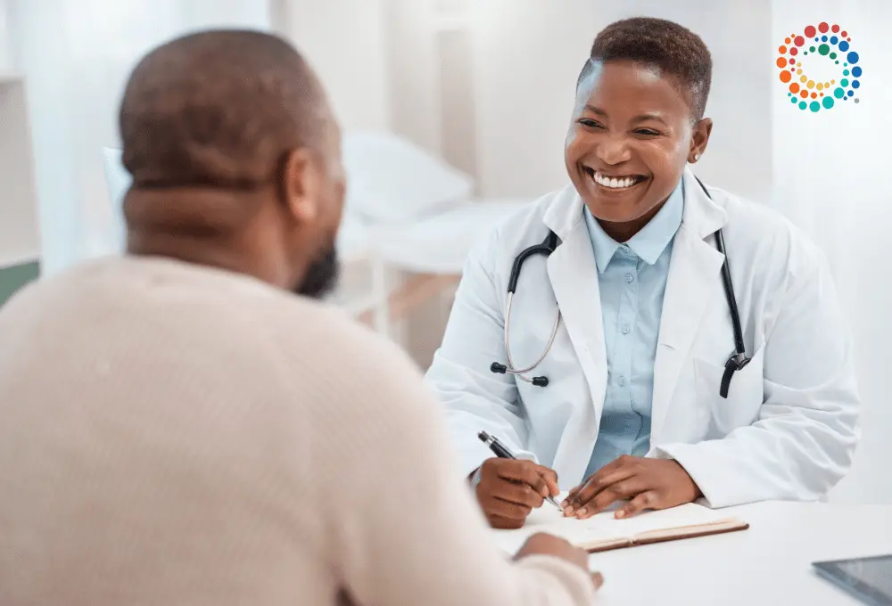 SMiling black doctor talking to patient