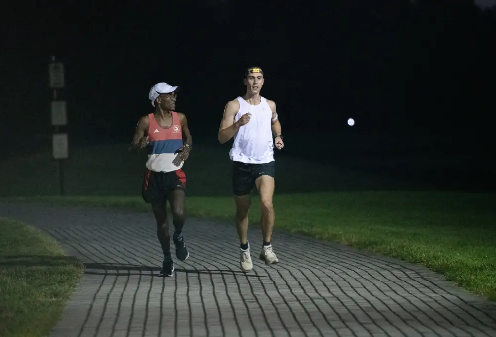 Two men jogging in the dark