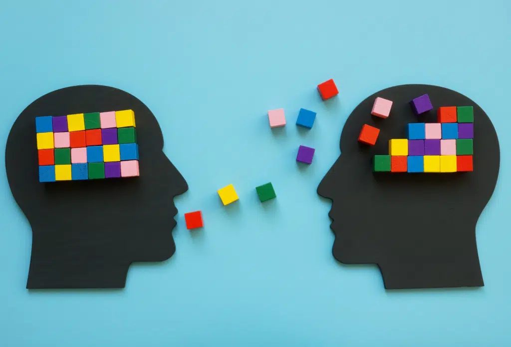 Blak head silhouettes surrounded by colorful blocks